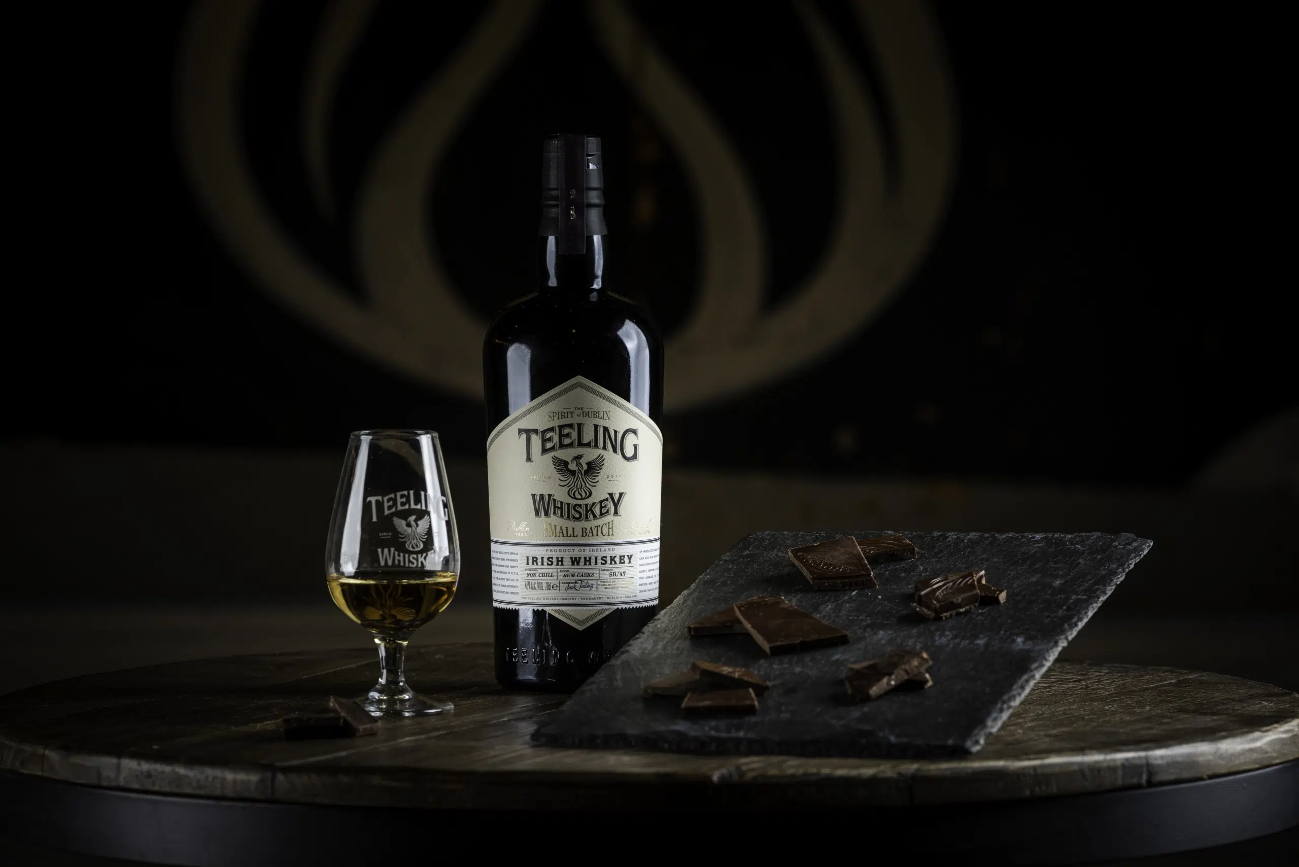 Teeling Whiskey Small Batch bottle with branded nosing glass and a selection of Dark Chocolate from Proper Chocolate Company Dubli
