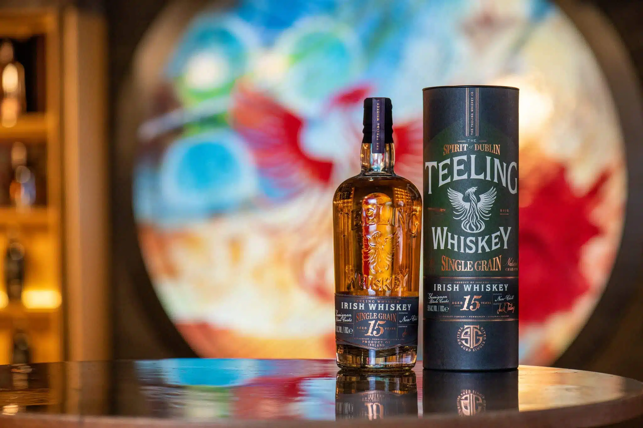 Teeling Single Grain 15-Year- Old in front of stain glass window with phoenix design at Teeling Whiskey Distillery