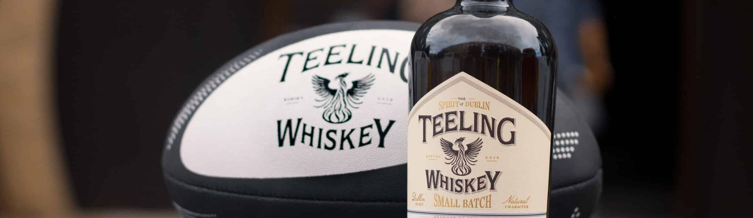 Teeling Small Batch with Rugby Ball in front of Teeling Whiskey Distillery
